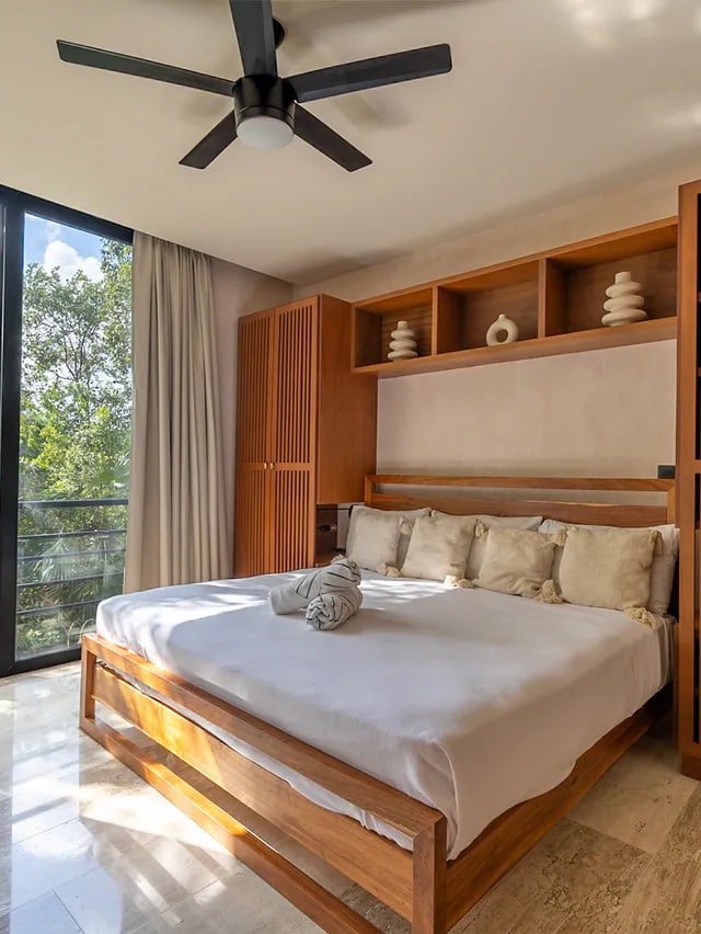 Sunlit vacation-rental bedroom photographed for property marketing