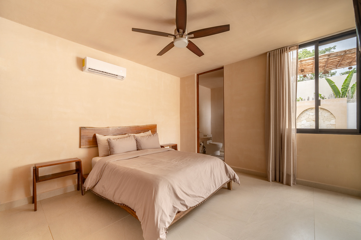 Bedroom with warm neutral walls, pendant lights, and full-height curtains — Surenna 21