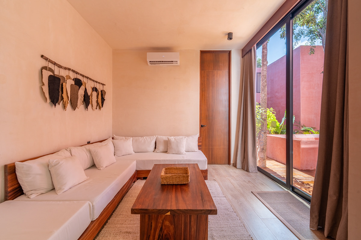 Living room with a built-in sectional opening onto a sunlit courtyard — Tulix 8