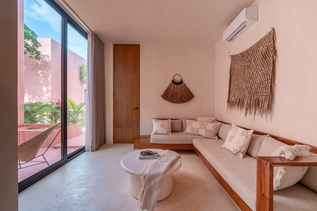 Living room with a wooden sofa and sliding doors to a rose-colored courtyard — Tulix 9