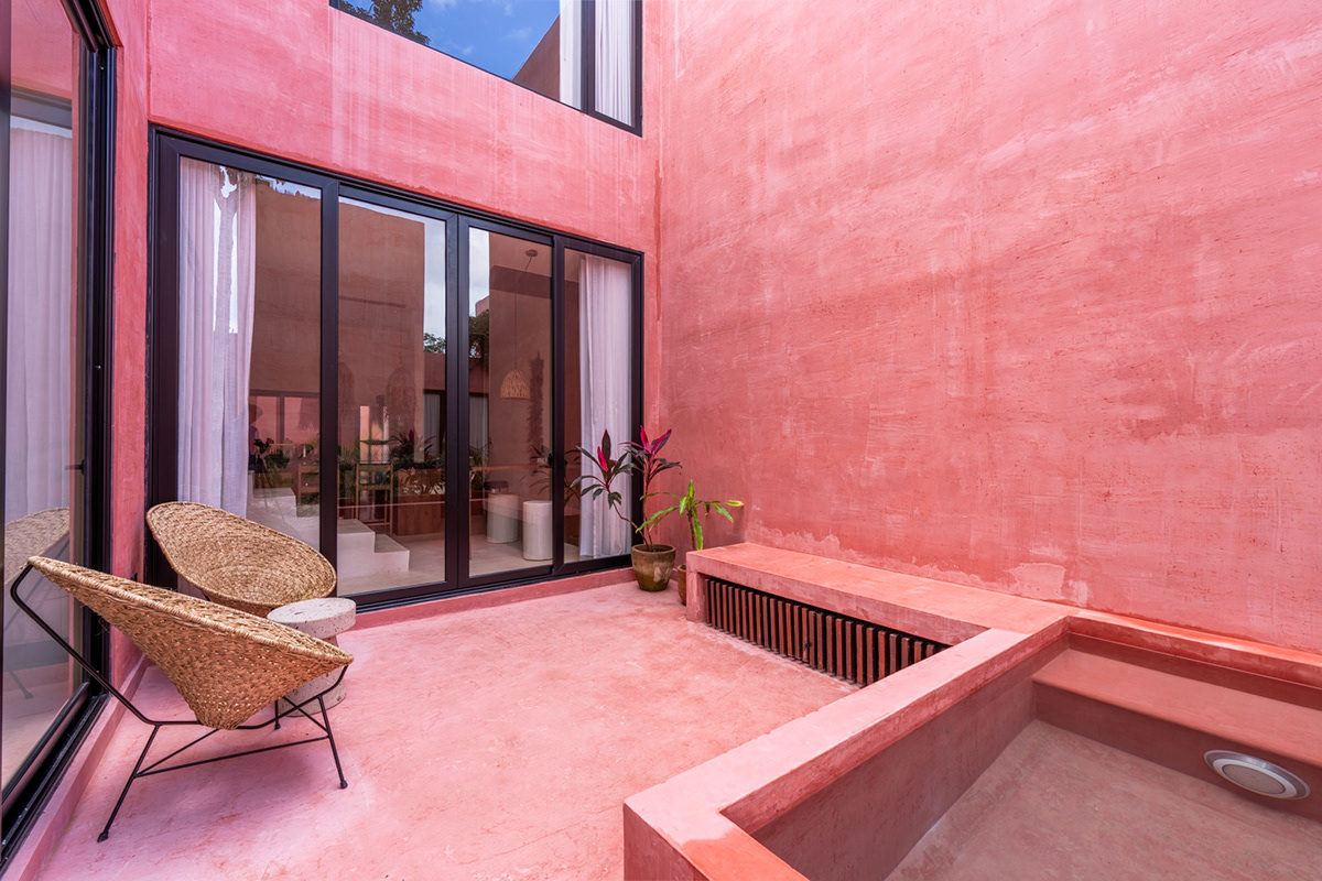 Courtyard seating beside a plunge pool and full-height glass doors — Tulix 9